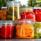 Jars of pickled vegetables and fruits in the garden